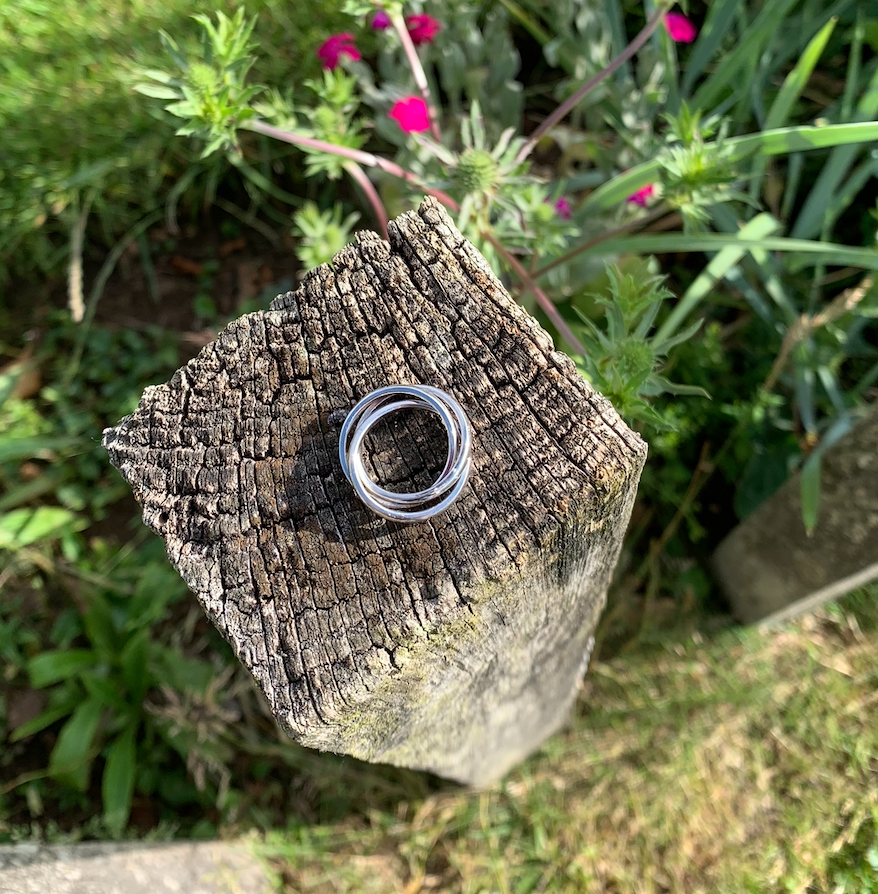 A sterling silver russian wedding ring with a hammered band.
