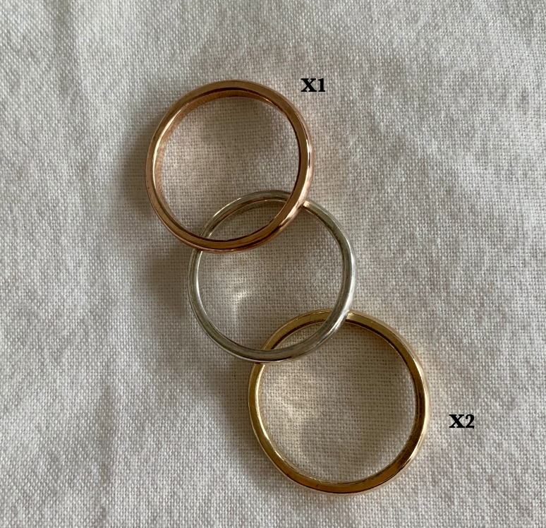 A triple-interlocking Russian wedding ring featuring two 9ct yellow gold bands and a 9ct rose gold band.